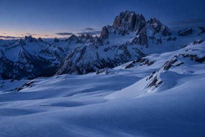 Paisaje de alta montaña nevado al anochecer, sin construcciones ni personas